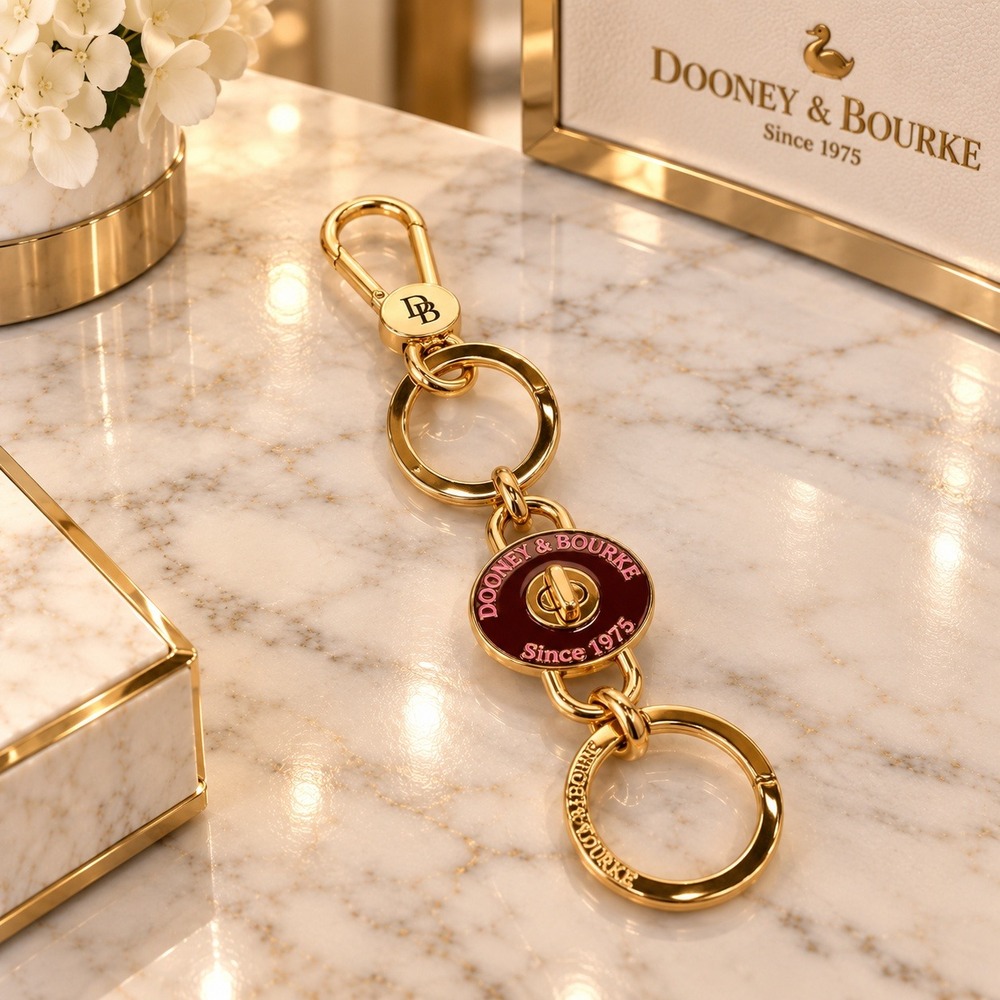 Dooney & Bourke Gold Tone Turnlock Key Charm Fob Pink Enamel Logo